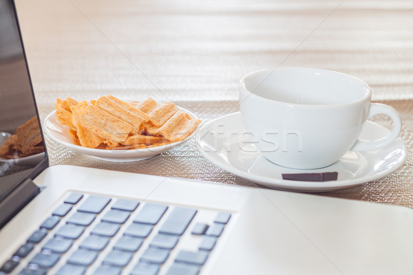 Laptop with coffee cup and snack Stock photo © punsayaporn