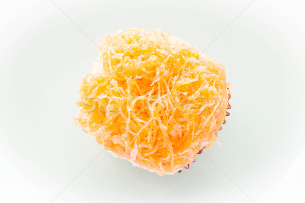 Stock photo: Gold egg yolk thread topped on cup cake 