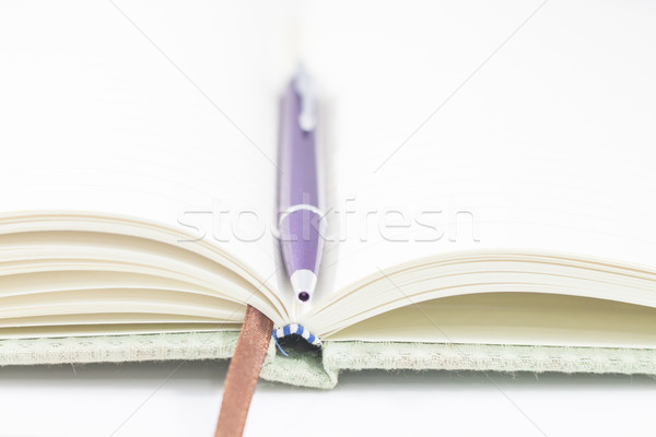 Stock photo: Closeup opened notebook and pen on white background