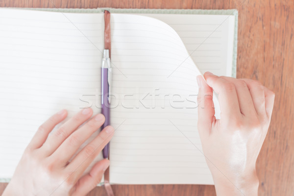 Woman turnover the paper Stock photo © punsayaporn