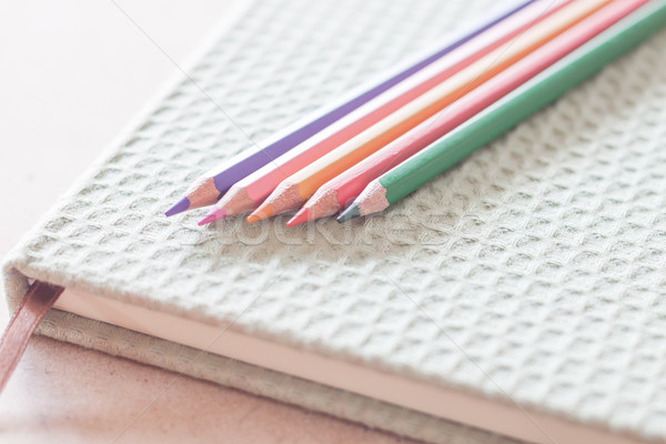 Closeup colorful pencils on green notebook Stock photo © punsayaporn