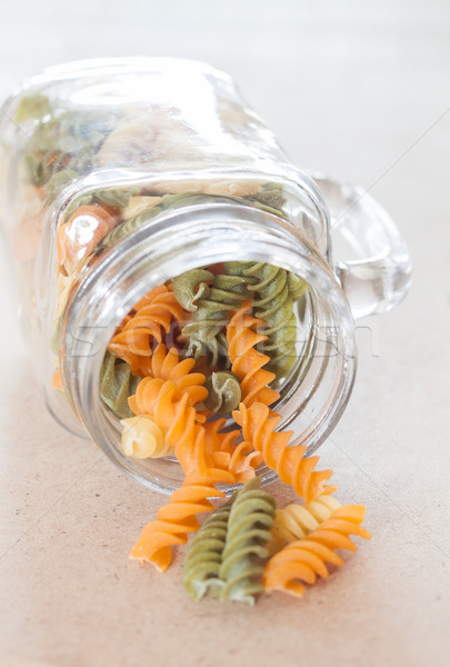 Raw fusilli pasta with glass bottle Stock photo © punsayaporn