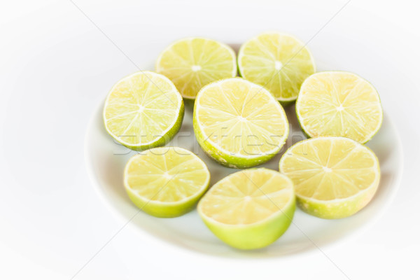 Fresh lime slice on white ceramic dish Stock photo © punsayaporn
