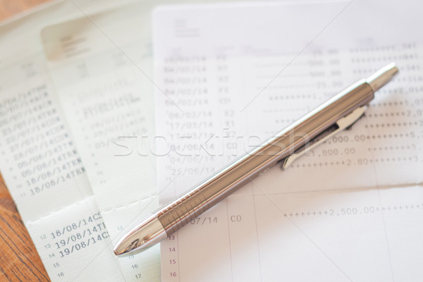 Three of bank account passbooks with pen Stock photo © punsayaporn