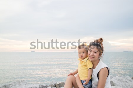 Asian boy chilling on the beach with his mother Stock photo © punsayaporn