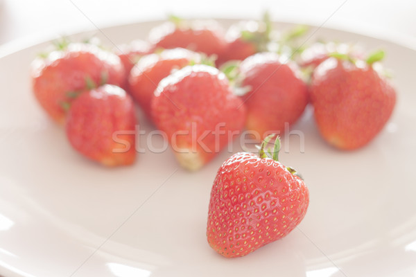 Fresh strawberries on white plate Stock photo © punsayaporn