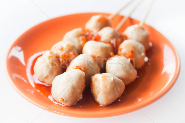 Stock photo: Mini pork balls in orange dish on clean table