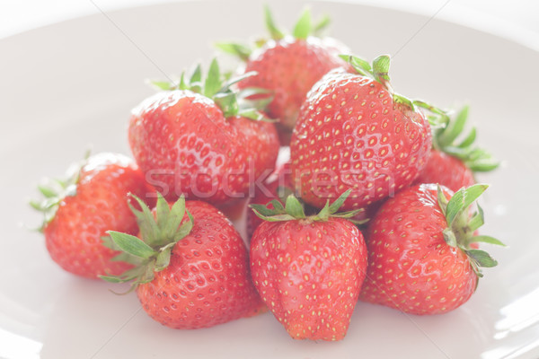 Fresh strawberries on white plate Stock photo © punsayaporn