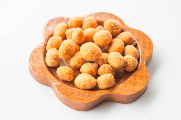 A mound of spicy peanut snack in wood dish  Stock photo © punsayaporn