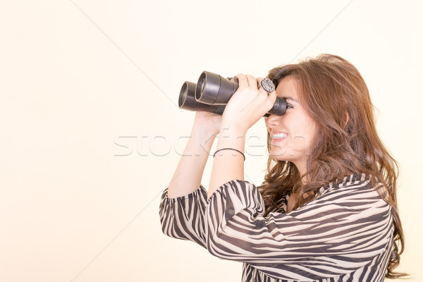 cute woman holding binoculars, yellow background Stock photo © pxhidalgo