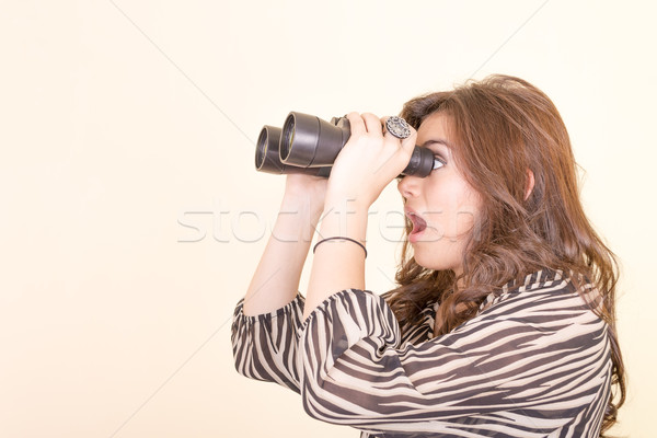 cute woman holding binoculars, yellow background Stock photo © pxhidalgo