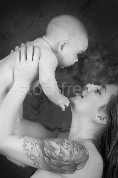 mother with tattoos holding a baby color processed Stock photo © pxhidalgo