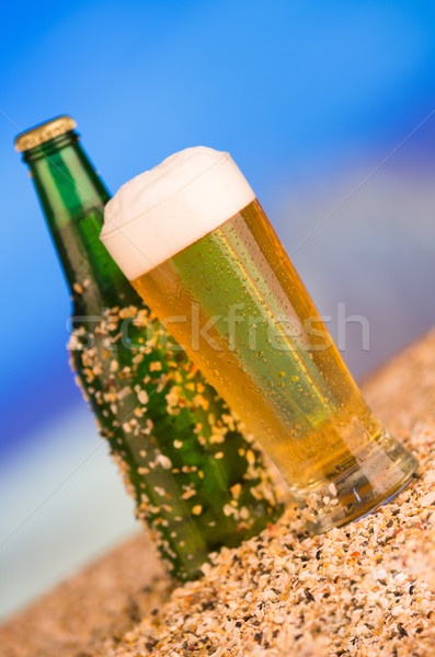 Ice cold green unlabelled bottle of beer in the beach concept Stock photo © pxhidalgo