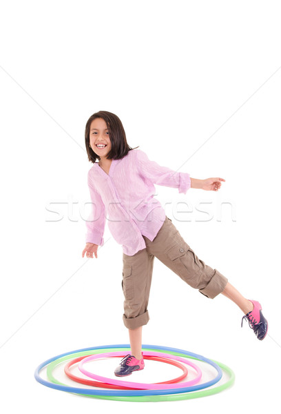 Young girl playing with hula hoop isolated over white background Stock photo © pxhidalgo
