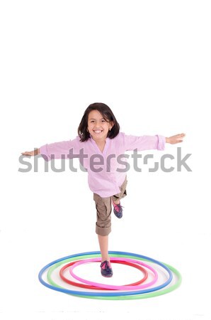 Young girl playing with hula hoop isolated over white background Stock photo © pxhidalgo