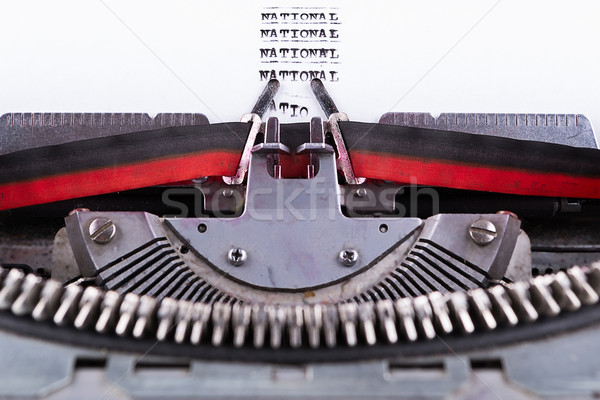 Stock photo: National written on an old typewriter .