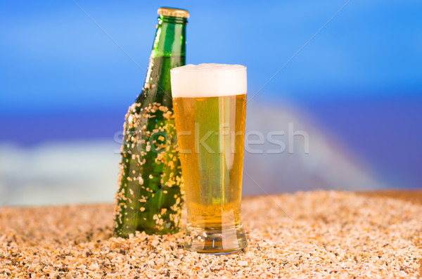Ice cold green unlabelled bottle of beer in the beach concept Stock photo © pxhidalgo