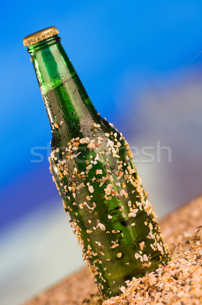 Ice cold green unlabelled bottle of beer in the beach concept Stock photo © pxhidalgo