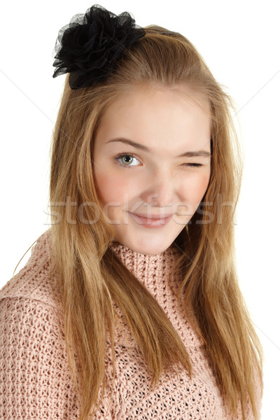 Playful young girl winks on white background Stock photo © pzaxe