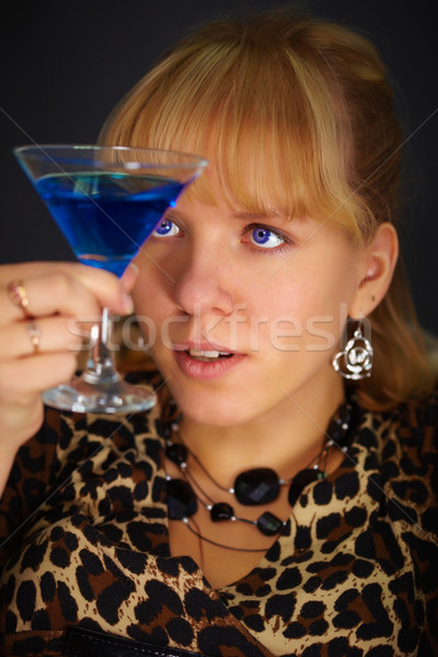 Young woman looks at glass with unusual cocktail Stock photo © pzaxe