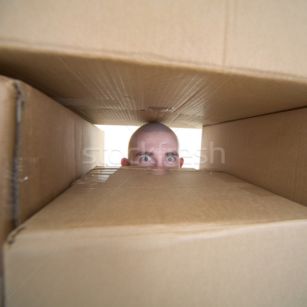 Face looking trough window in pile cardboards Stock photo © pzaxe