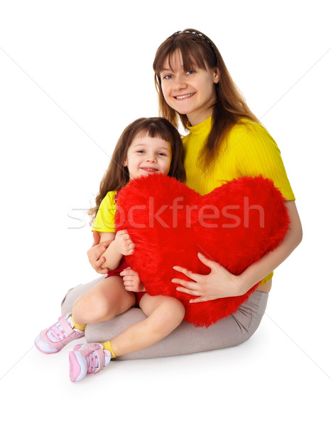Stock photo: Mom and daughter with a toy heart in hands