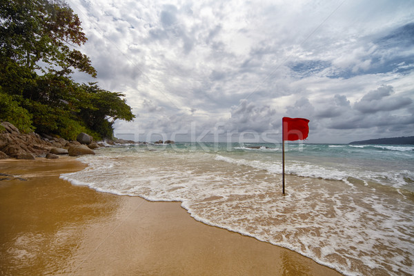  Secluded beach with a red flag Stock photo © pzaxe