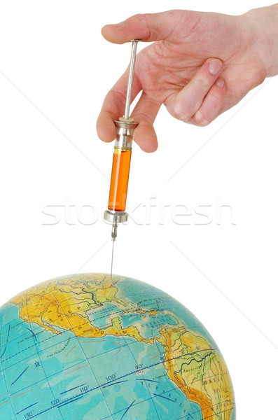 Syringe and terrestrial globe Stock photo © pzaxe
