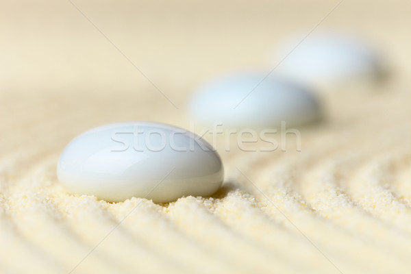 Three white drops on surface of yellow sand Stock photo © pzaxe