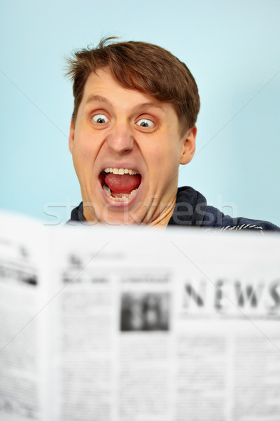 Man shocked - bad news from newspaper Stock photo © pzaxe