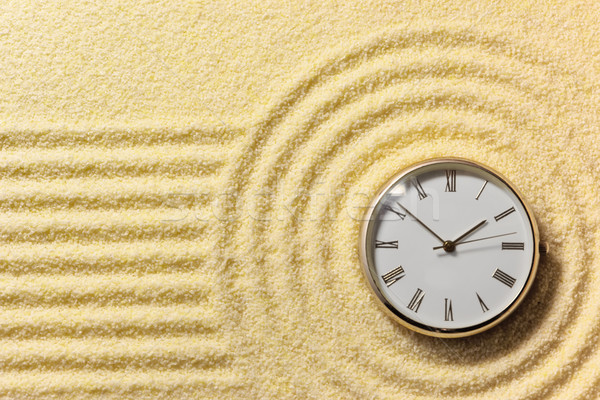 Old watch on surface of golden sand Stock photo © pzaxe