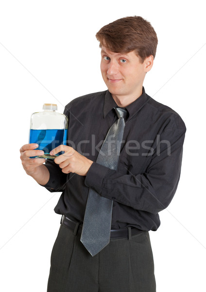 Cheerful man with vial of a blue liquid Stock photo © pzaxe