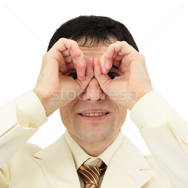 Businessman looking through fingers like a pair of binoculars Stock photo © pzaxe