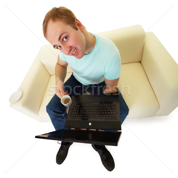 Emotional man with a laptop and a cup of coffee Stock photo © pzaxe