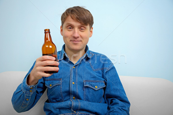 Stock photo: Man relaxing with a bottle of beer