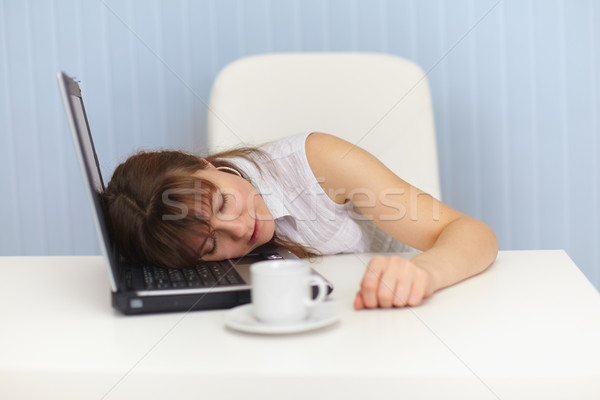 Young woman sleeps on laptop keyboard on workplace Stock photo © pzaxe