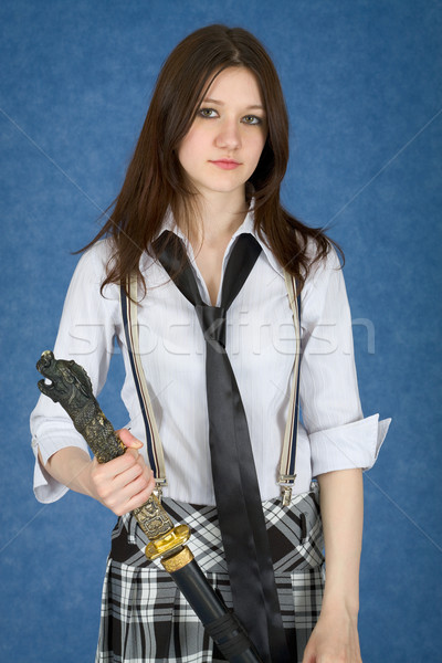 Beautiful girl standing on blue background with japanese sword Stock photo © pzaxe