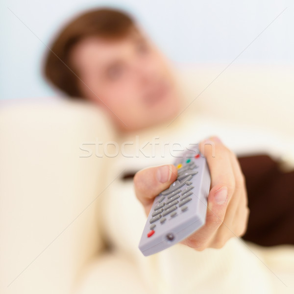 Man aims in TV the remote control Stock photo © pzaxe