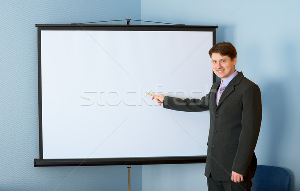 Businessman near the white screen Stock photo © pzaxe