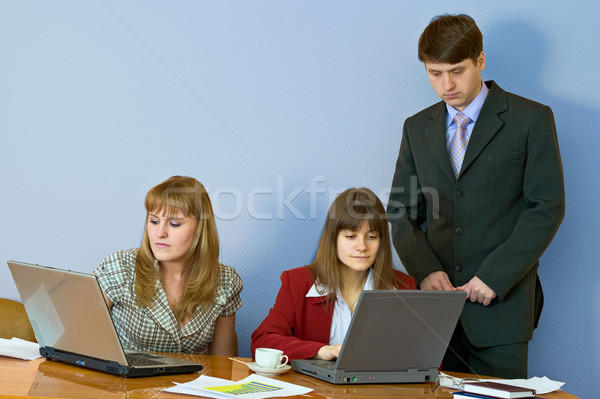 Girls at a desktop and their chief Stock photo © pzaxe