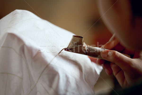 Making batik process. Application of wax on fabric Stock photo © pzaxe