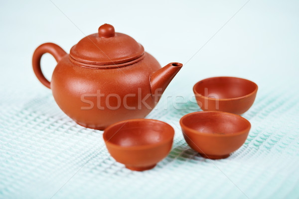 Ceramic teapot and cups on blue towel Stock photo © pzaxe