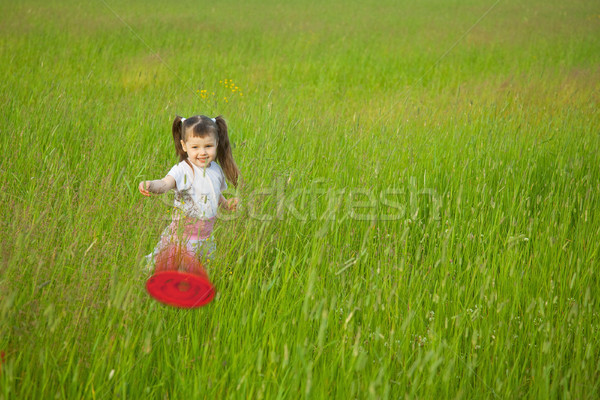 Little girl starts a flying disk Stock photo © pzaxe