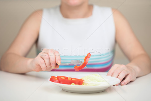 Woman eats vegetables keeping to strict vegetarian diet Stock photo © pzaxe