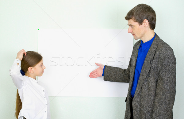 Teacher explains something to the schoolgirl Stock photo © pzaxe