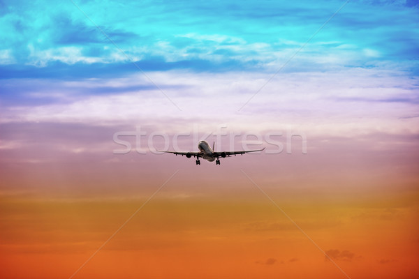 Passenger plane takes off at sunset Stock photo © pzaxe
