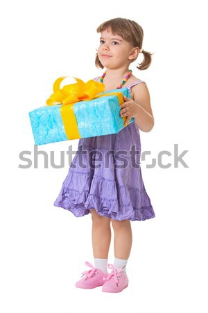 Stock photo: Little girl holding a gift - birthday