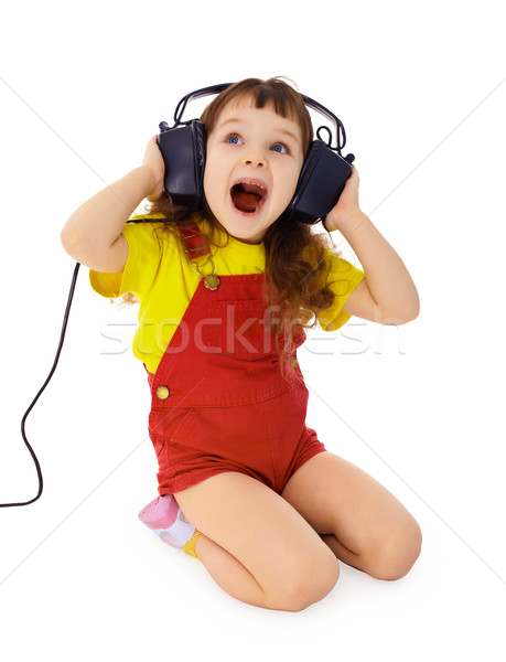 Cheerful little girl sings the music Stock photo © pzaxe