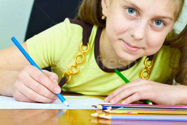Girl holding a blue pencil Stock photo © pzaxe