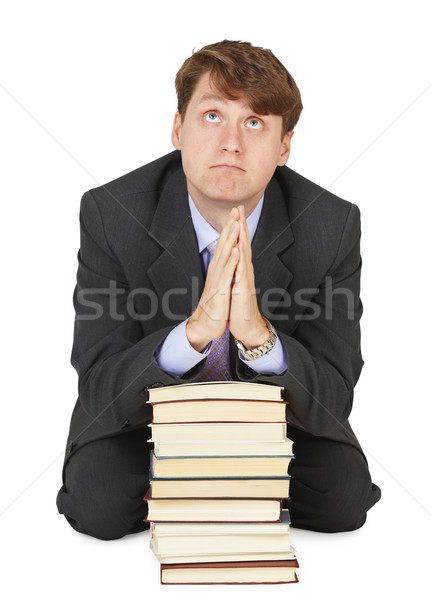 Student prays before examination on pile of textbooks Stock photo © pzaxe